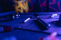 Silver Spoon Beside White Cigarette Stick on Blue Table