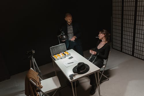 Free A Woman and a Law Officer Inside the Interrogation Room Stock Photo