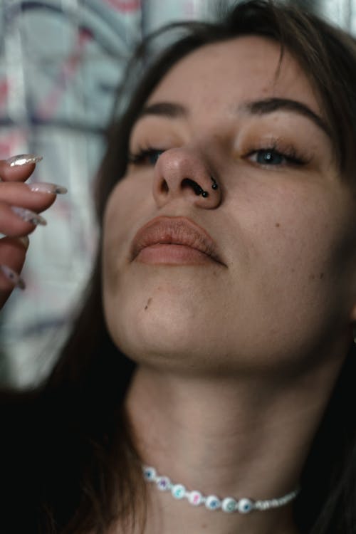 Close-Up Shot of a Woman With Nose Piercing 