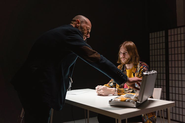 Man With Long  Hair Sitting At The Table