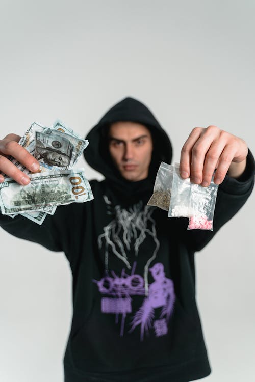 Free A Man in Black Hoodie Sweater Engaged in Illegal Drugs Trade Stock Photo
