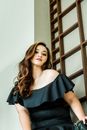 Photo of a Woman in a Black Off Shoulder Top