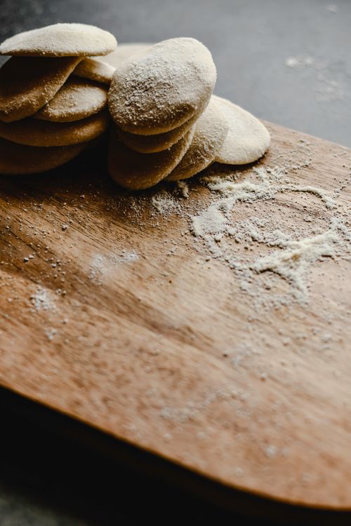 Free Close-up of handmade dumpling dough on a wooden board in natural light. Stock Photo