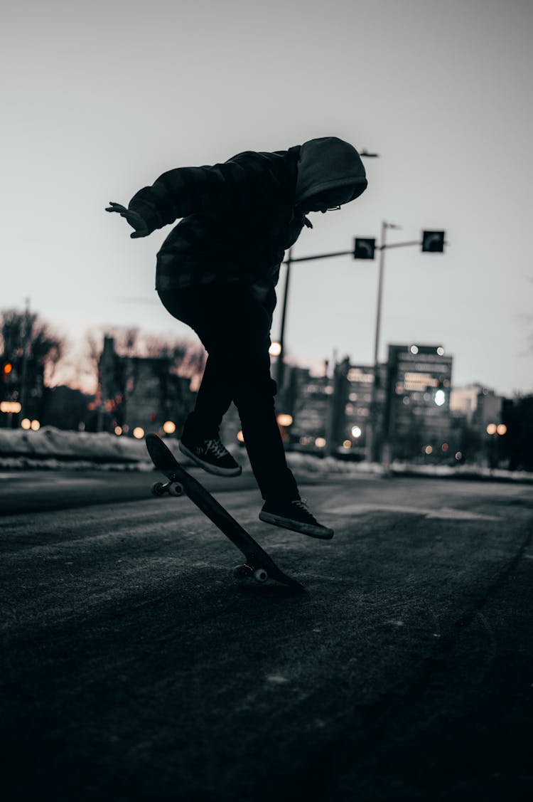 Person In Black Hoodie Jacket Skateboarding