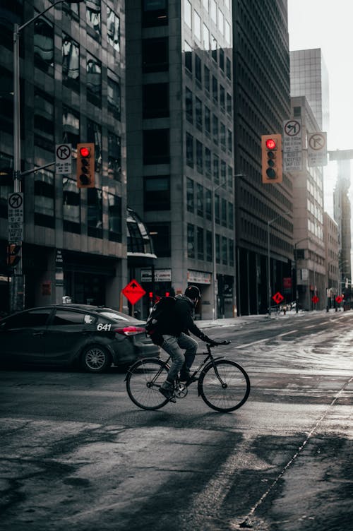 Photo of a Person Riding a Bicycle on a Road