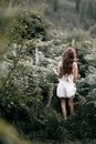 Woman Standing on Bushes