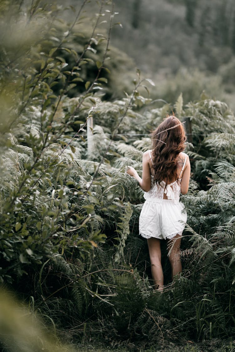 Woman Standing On Bushes