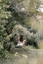 Woman in White Shirt Sitting on Green Grass