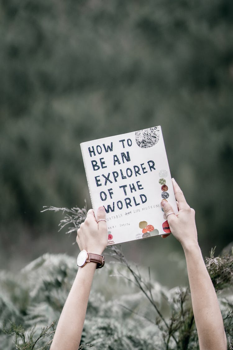 Photo Of A Person's Hands Holding A Book