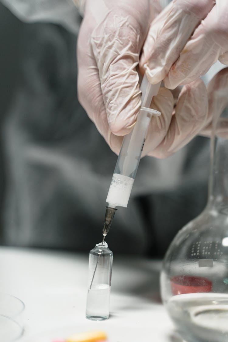 Hand With Syringe On Vial