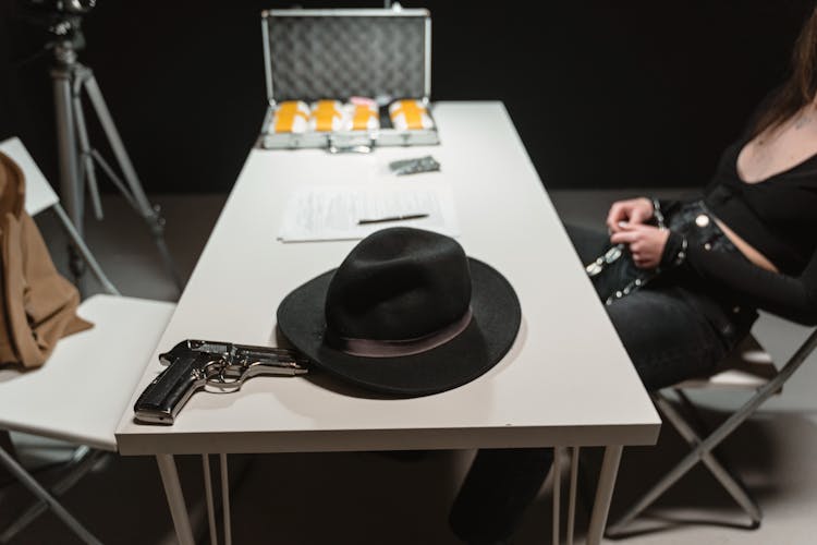 Hat And Gun On A Table