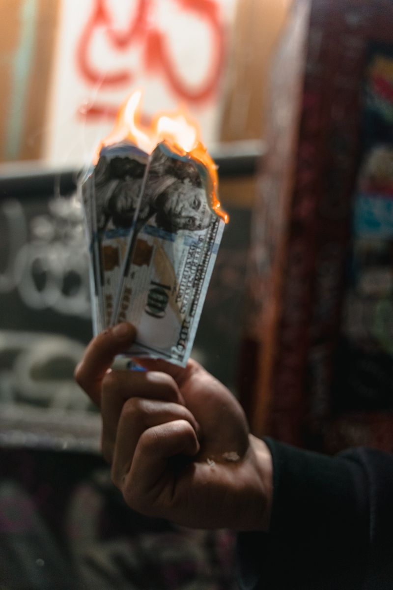 Burning money representing wasted paid advertising budget versus free AI organic traffic