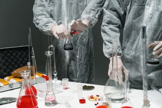 Researchers in protective gear performing experiments in a scientific laboratory.