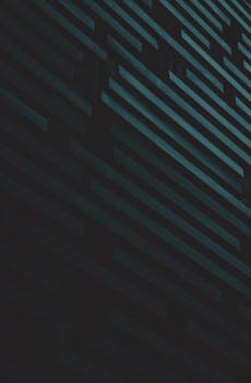 Abstract view of a dark geometric modern facade with vertical lines.