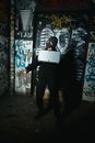 Person in Black Jacket with Mask Holding a Silver Briefcase and Gun