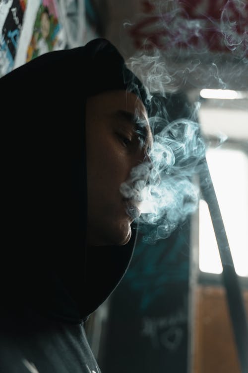 Free Man in Black Hoodie Jacket Smoking Stock Photo