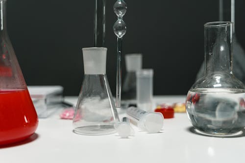 Clear Glass Bottles on White Table