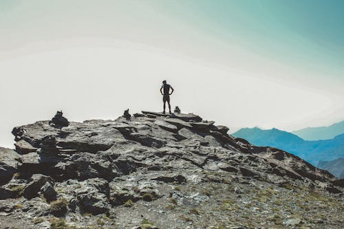 Free Person Standing on the Cliff Stock Photo