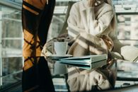 Person in White and Gray Stripe Dress Shirt Reading Book