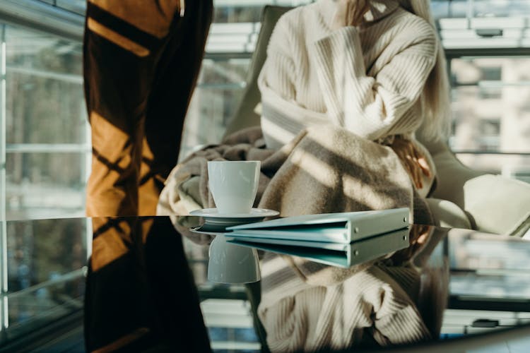 Photograph Of A Cup Near A Binder