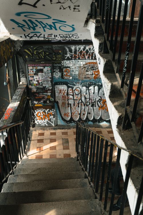 Free A stairwell in an urban setting covered with colorful graffiti and street art. Stock Photo