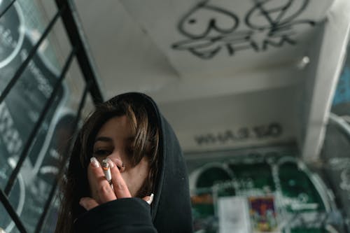 Woman in Black Hoodie Covering Her Face