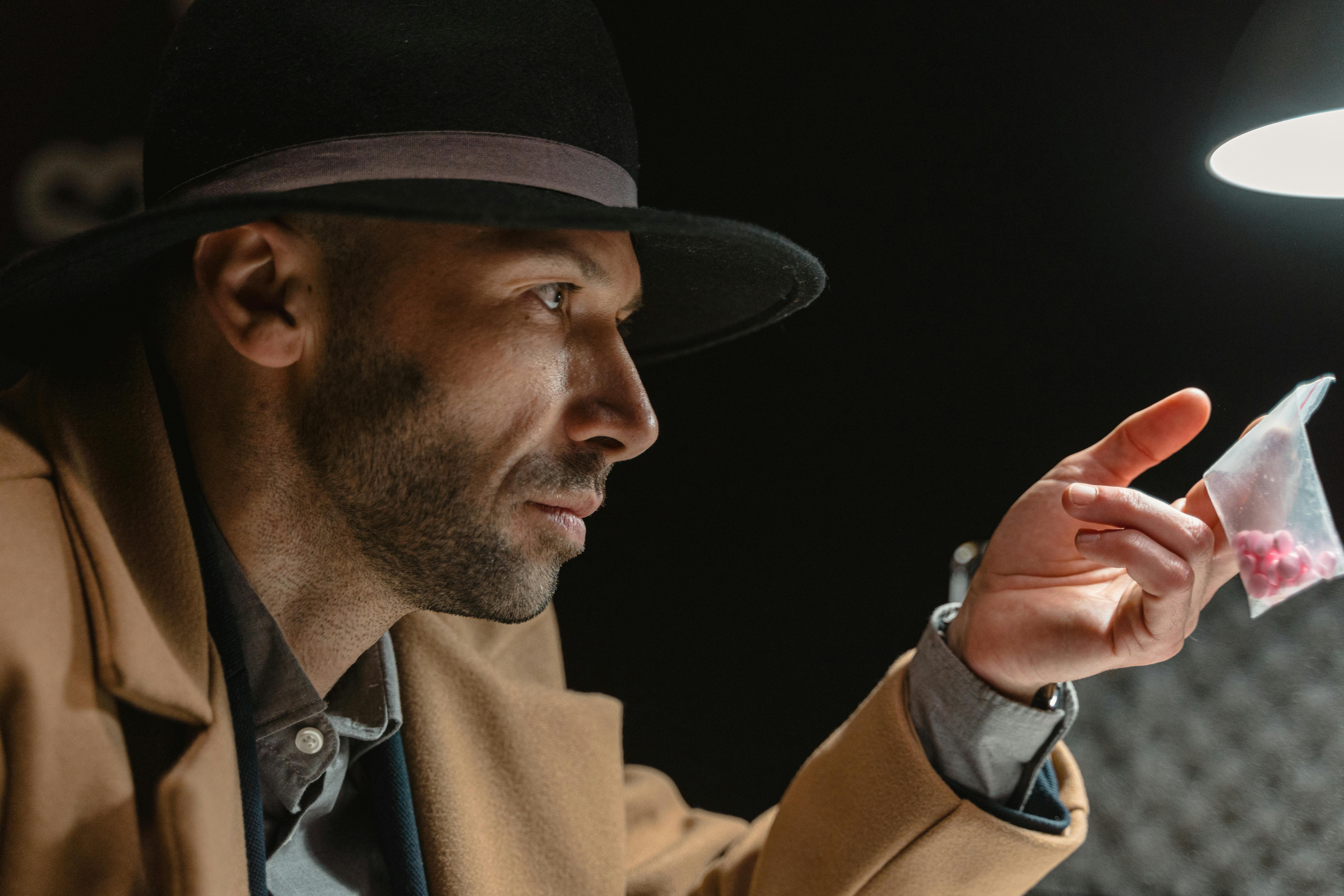 man in brown coat and black hat