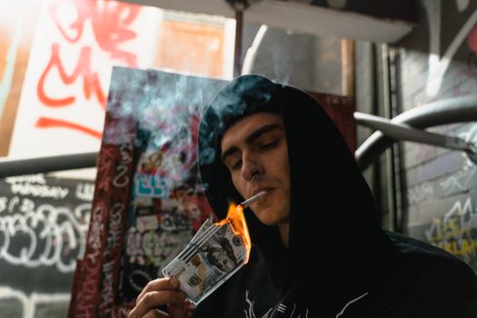 Man in Black Hoodie Smoking Cigarette