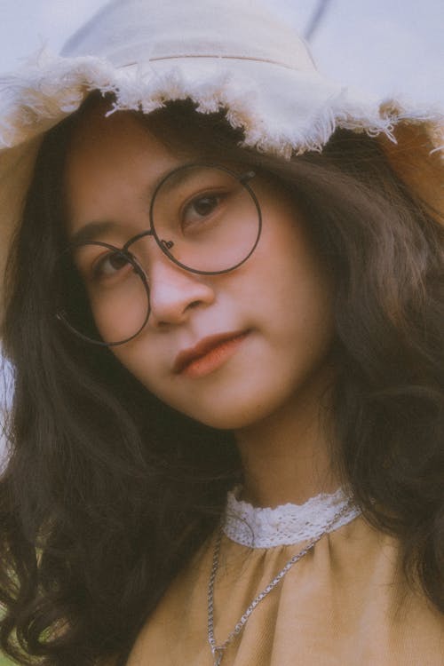 Photo of a Girl with a Hat and Eyeglasses