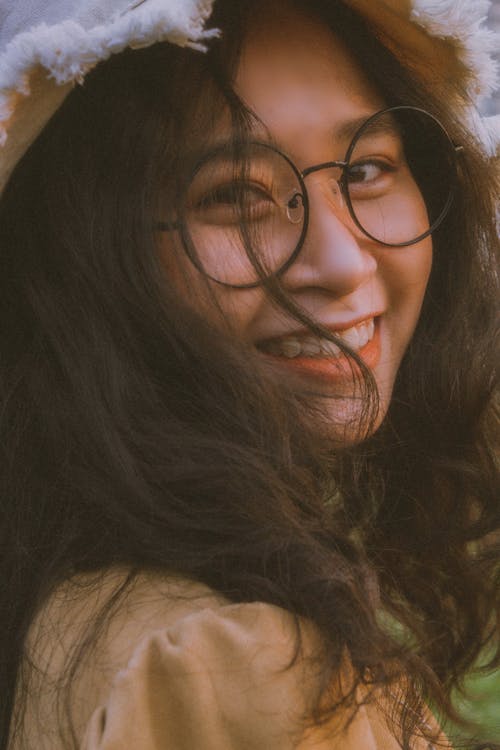 Portrait of a Girl with Black Framed Eyeglasses Smiling