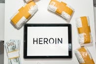Conceptual Packages of Heroin over a White Table