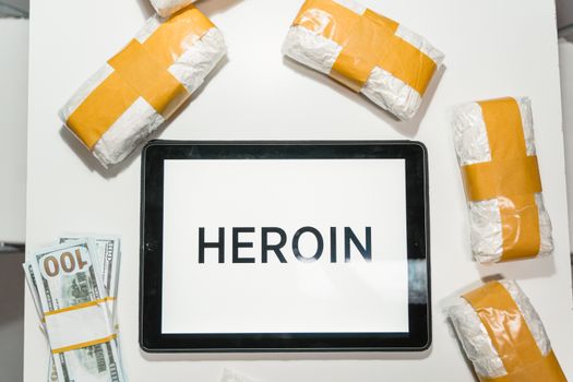  Conceptual Packages of Heroin over a White Table