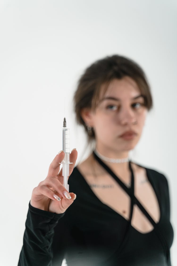 A Woman Holding A Syringe