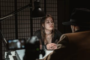 Woman in Black Coat Sitting on Chair