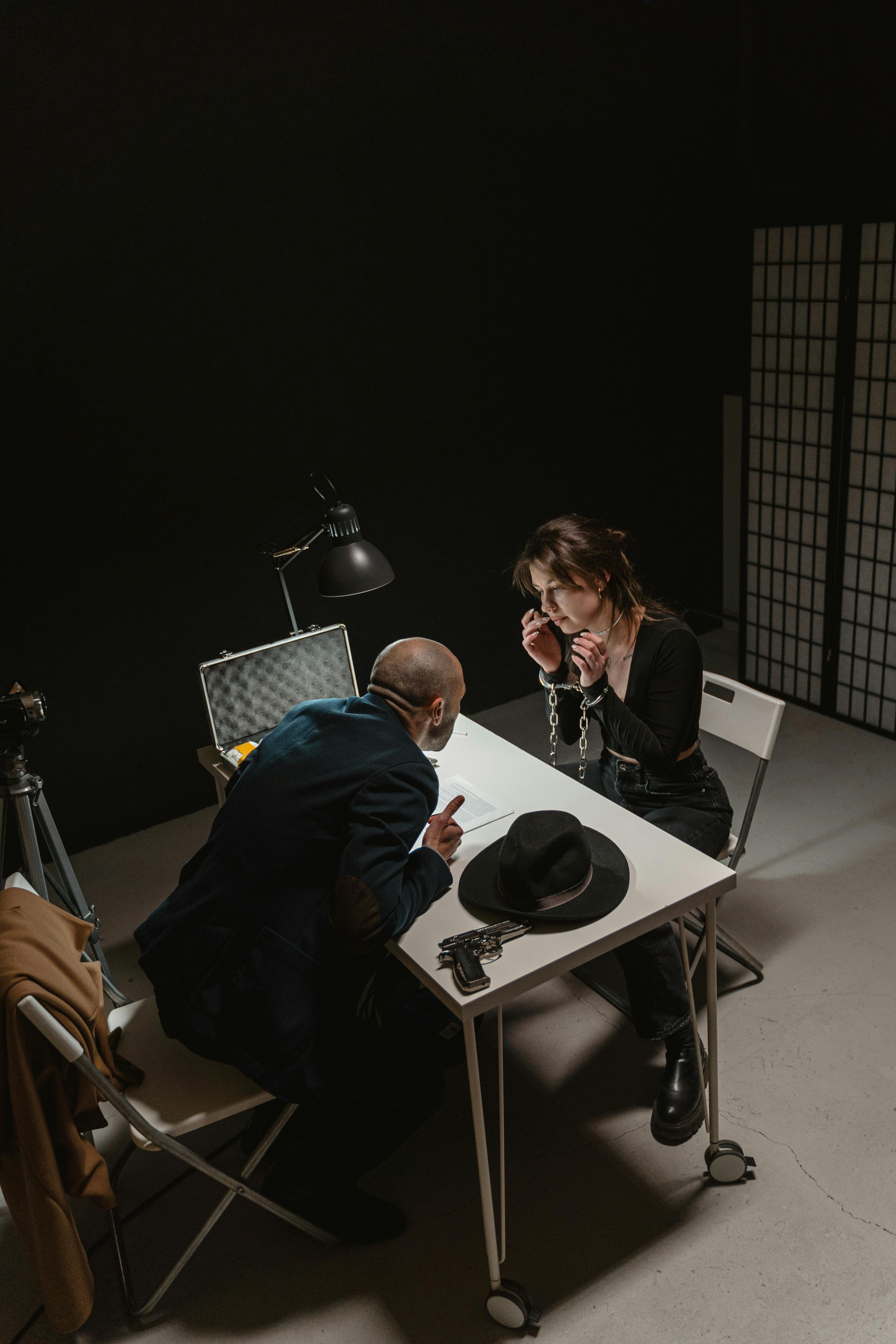 man and woman sitting on chair in front of table