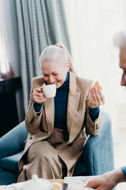 An Elderly Woman Having Coffee 