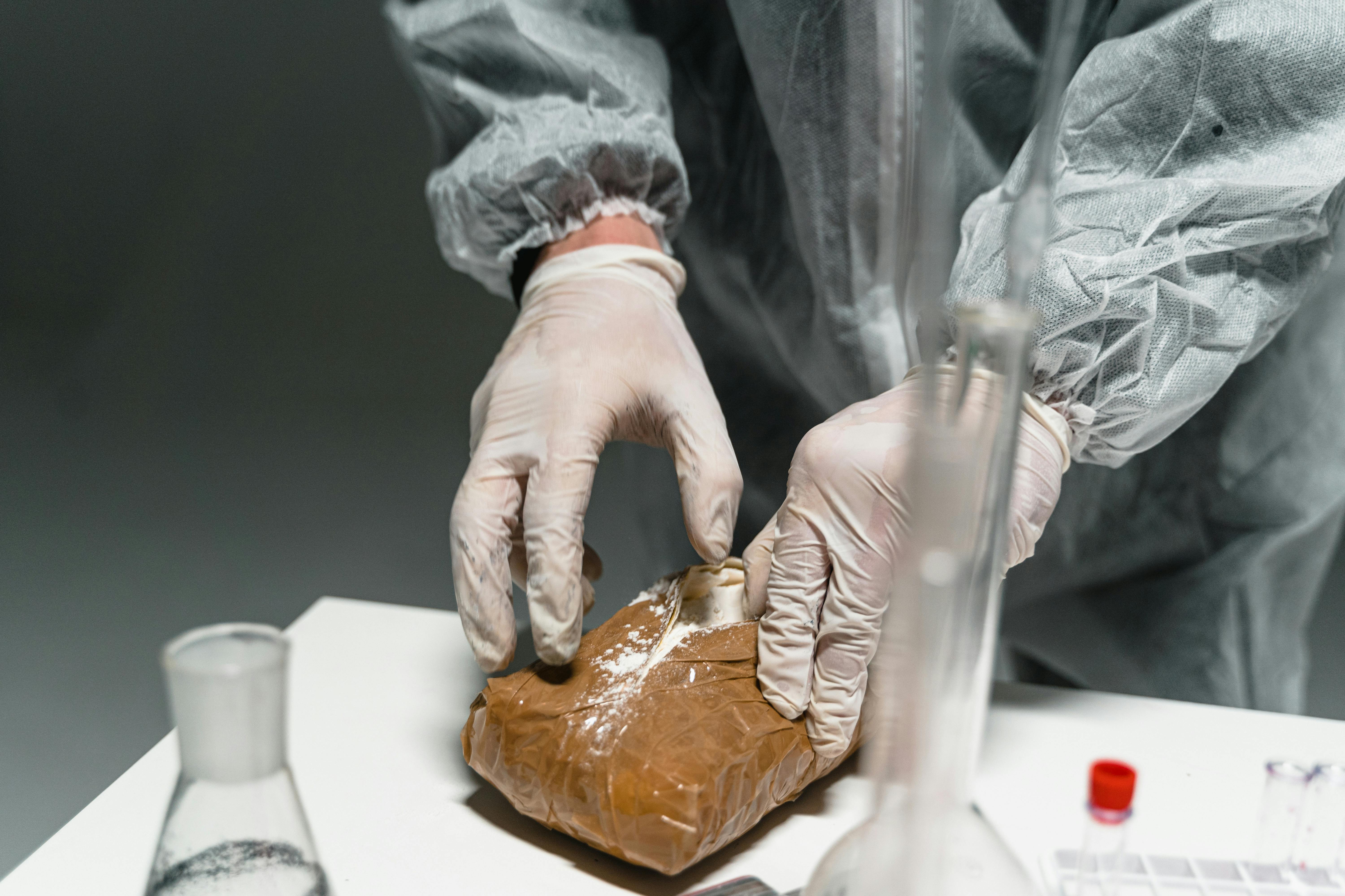 a person wearing a latex gloves opening a package