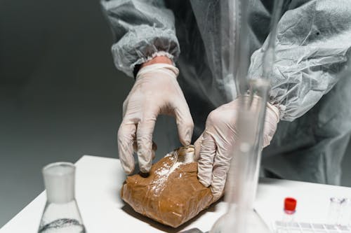 Free A Person Wearing a Latex Gloves Opening a Package Stock Photo