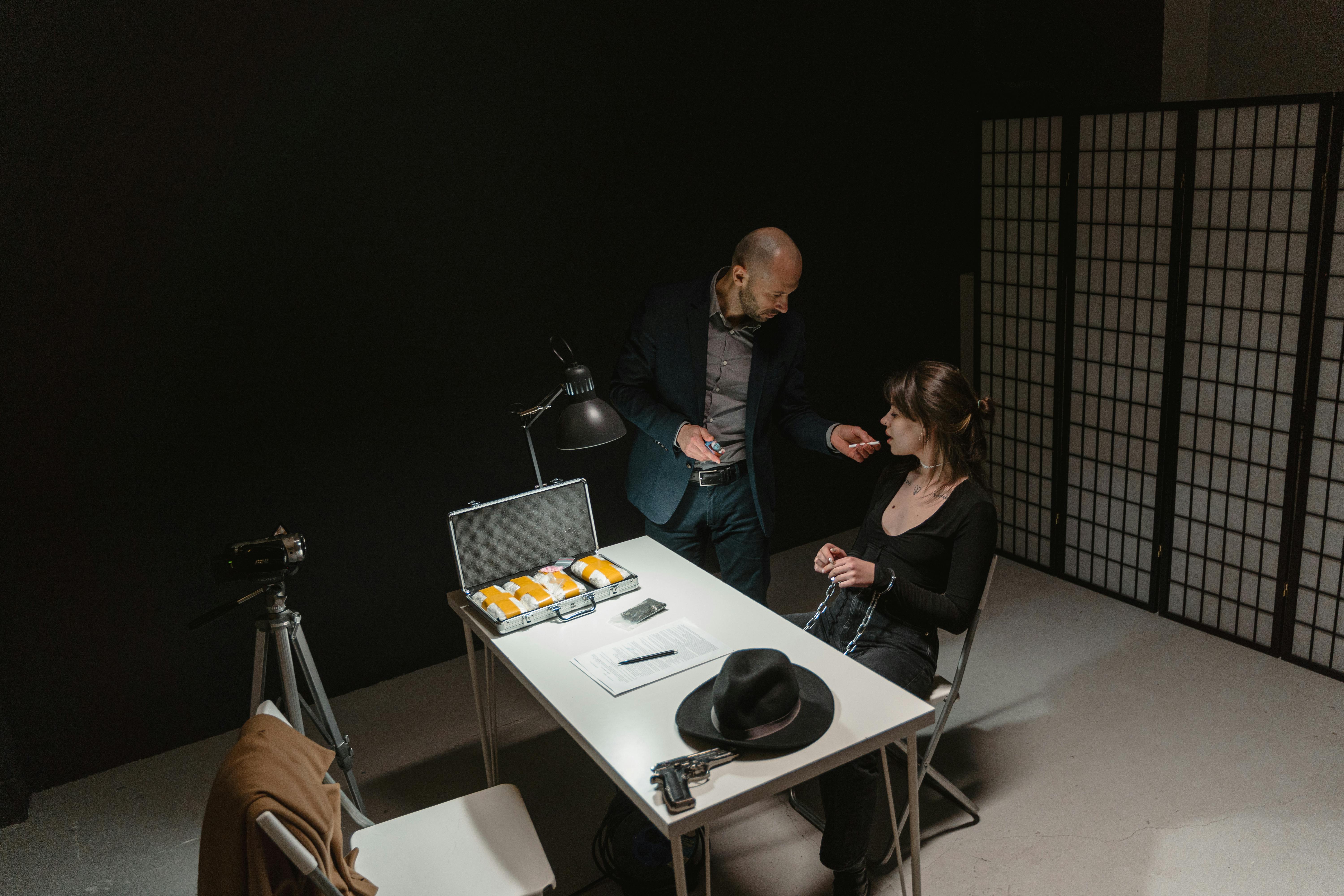 man in black suit jacket sitting beside woman in black long sleeve shirt