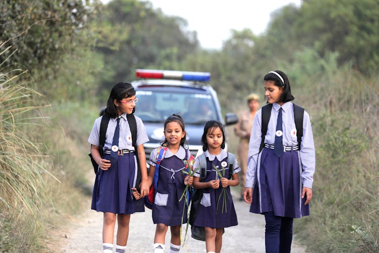 Young Students Walking With Police Escorts