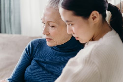 Free A loving bond between an elderly woman and a younger adult indoors. Stock Photo