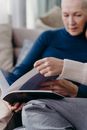 Woman in Blue Turtleneck Sweater Reading Book