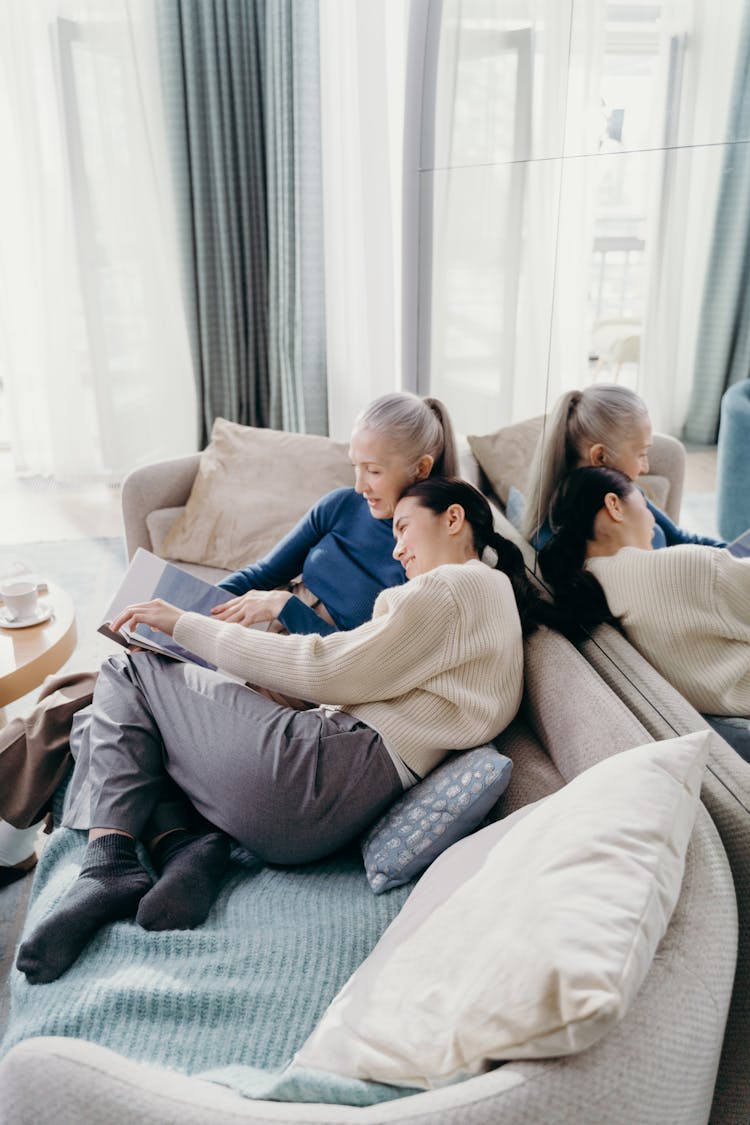 Elderly Woman And Woman Sitting On Couch