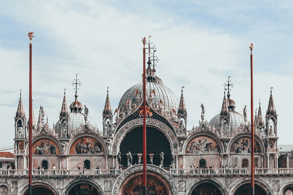 Stunning view of St. Mark's Basilica featuring ornate domes and Gothic architecture in Venice, Italy.