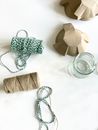 Brown and Green Yarns on White Surface