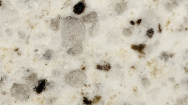 A detailed close-up of a speckled stone surface with natural textures and patterns.