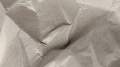 Free Detailed close-up of crumpled and textured paper surface showcasing natural patterns. Stock Photo