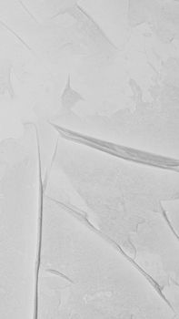 Detailed close-up of a white textured surface with abstract patterns.