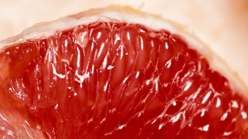 Free Detailed macro shot of a fresh juicy grapefruit, highlighting the rich red pulp and natural texture. Stock Photo