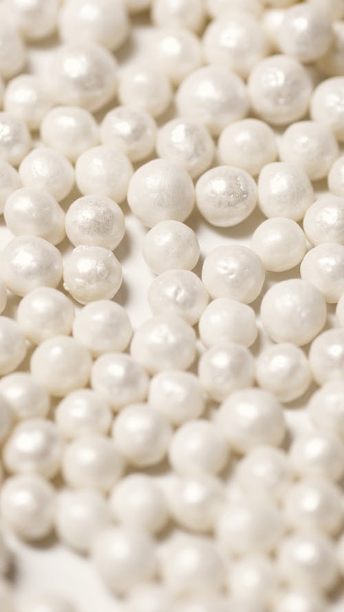 White Beads on Brown Wooden Table